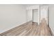 Bright bedroom featuring wood-look flooring and a closet with sliding mirrored doors at 1832 N Decatur Blvd # 104, Las Vegas, NV 89108