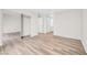 Spacious bedroom with wood-look flooring, a mirrored closet, and plenty of natural light at 1832 N Decatur Blvd # 104, Las Vegas, NV 89108