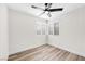 Bedroom featuring light hardwood flooring, two windows, and a ceiling fan at 1832 N Decatur Blvd # 104, Las Vegas, NV 89108