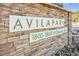 Stone community sign for Avila Park with address, set against a textured stone wall at 1832 N Decatur Blvd # 104, Las Vegas, NV 89108