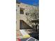 Exterior view of a condo unit with covered parking, a walkway, and desert landscaping at 1832 N Decatur Blvd # 104, Las Vegas, NV 89108