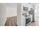 Bright kitchen with white cabinets, stainless steel appliances and wood-look flooring at 1832 N Decatur Blvd # 104, Las Vegas, NV 89108