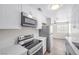 Bright kitchen with white cabinetry, stainless steel appliances and wood-look flooring at 1832 N Decatur Blvd # 104, Las Vegas, NV 89108