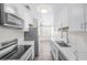Bright kitchen with white cabinetry, stainless steel appliances and wood-look flooring at 1832 N Decatur Blvd # 104, Las Vegas, NV 89108