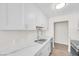 Bright kitchen featuring white cabinets, modern countertops, and stainless steel appliances at 1832 N Decatur Blvd # 104, Las Vegas, NV 89108