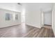 Living room featuring light hardwood flooring, a window, and a new front door at 1832 N Decatur Blvd # 104, Las Vegas, NV 89108