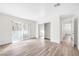 Bright living room featuring wood-look floors, closet, and sliding glass doors to the outside at 1832 N Decatur Blvd # 104, Las Vegas, NV 89108