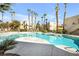 Community pool with palm trees providing a resort-style ambiance in a neighborhood with apartment buildings at 1832 N Decatur Blvd # 104, Las Vegas, NV 89108