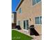 Backyard with artificial grass, patio with a BBQ, and a fence, perfect for entertaining at 1885 Vass Springs Pl, North Las Vegas, NV 89084