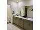 This modern bathroom includes double sinks, ample counter space, and stylish fixtures for a luxurious feel at 1885 Vass Springs Pl, North Las Vegas, NV 89084