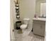 This well-appointed bathroom features a modern toilet, decorative shelves, and a granite countertop sink at 1885 Vass Springs Pl, North Las Vegas, NV 89084