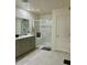Spacious bathroom showcasing a glass enclosed shower and double vanity at 1885 Vass Springs Pl, North Las Vegas, NV 89084