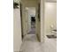 Clean bathroom with tile flooring, a toilet, and hallway access at 1885 Vass Springs Pl, North Las Vegas, NV 89084