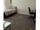 This bedroom features plush carpeting, a comfortable bed, and a functional workspace with a desk and chair at 1885 Vass Springs Pl, North Las Vegas, NV 89084