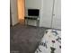 Carpeted bedroom featuring a double door closet, accent table, and TV stand at 1885 Vass Springs Pl, North Las Vegas, NV 89084