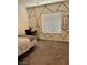 Bright bedroom with patterned wall, mirror, and a comfortable workspace at 1885 Vass Springs Pl, North Las Vegas, NV 89084
