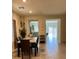Dining room featuring neutral tones, designer lighting, and a transition to an outdoor area at 1885 Vass Springs Pl, North Las Vegas, NV 89084