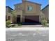 Inviting two-story home boasting a modern design with a two-car garage and easy-care landscaping at 1885 Vass Springs Pl, North Las Vegas, NV 89084