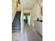 Inviting hallway with gray stairs and modern decor leads to a bright, open space at 1885 Vass Springs Pl, North Las Vegas, NV 89084