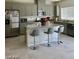 Well-equipped kitchen featuring stainless steel appliances, granite countertops, and a functional island at 1885 Vass Springs Pl, North Las Vegas, NV 89084