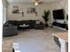 Spacious living room showcases a comfortable sectional, entertainment center, and oversized windows at 1885 Vass Springs Pl, North Las Vegas, NV 89084