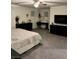 Spacious main bedroom with a ceiling fan, two windows, and dark furniture at 1885 Vass Springs Pl, North Las Vegas, NV 89084