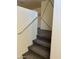 Carpeted staircase with white walls, with a modern design on the wall at 1885 Vass Springs Pl, North Las Vegas, NV 89084