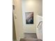 Carpeted staircase with white walls, with a modern art piece on the wall at 1885 Vass Springs Pl, North Las Vegas, NV 89084