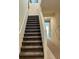 Carpeted stairs lead to the upper level of this modern home at 1885 Vass Springs Pl, North Las Vegas, NV 89084