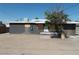 Back view of a single-story home featuring a dirt backyard, boarded windows and weathered facade at 1912 Statz St, North Las Vegas, NV 89030