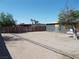 The backyard is dirt, with wood fencing and a tree at 1912 Statz St, North Las Vegas, NV 89030