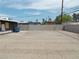 Backyard featuring a partial concrete block wall and some trees in the background at 1912 Statz St, North Las Vegas, NV 89030