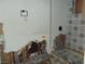 Bathroom with damaged walls and partial tile, prime for renovation and customized design at 1912 Statz St, North Las Vegas, NV 89030