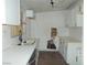 Updated kitchen featuring white cabinetry, stainless steel dishwasher and subway tile at 1912 Statz St, North Las Vegas, NV 89030