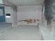 Living room with blue accent wall, peeling paint and a rock fireplace at 1912 Statz St, North Las Vegas, NV 89030
