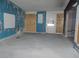 Living room featuring peeling paint, a partially boarded up wall, and painted blue trim at 1912 Statz St, North Las Vegas, NV 89030