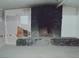Living room featuring a rock fireplace at 1912 Statz St, North Las Vegas, NV 89030
