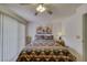 Cozy bedroom featuring a decorative bedspread, ceiling fan, and slider door to the exterior at 1944 Las Palmas Ln # 174, Laughlin, NV 89029