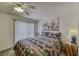 Cozy bedroom featuring a decorative bedspread, ceiling fan, and slider door to the exterior at 1944 Las Palmas Ln # 174, Laughlin, NV 89029