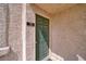 Exterior door with olive paint, brass hardware, and unit number in a well-maintained condo at 1944 Las Palmas Ln # 174, Laughlin, NV 89029
