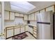 Bright kitchen features white cabinets, modern appliances, and a skylight, perfect for home cooking at 1944 Las Palmas Ln # 174, Laughlin, NV 89029