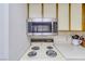 View of the kitchen stove with the microwave above, showing the cooking area at 1944 Las Palmas Ln # 174, Laughlin, NV 89029