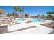 Community pool surrounded by lounge chairs, palm trees and lush landscaping at 1944 Las Palmas Ln # 174, Laughlin, NV 89029