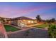 Sprawling backyard featuring synthetic turf, stone tile patio, lounge area, and desert landscaping at 20 Kittansett Loop, Henderson, NV 89052