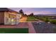 Large backyard featuring synthetic turf, stone tile patio, lounge area, and drought tolerant landscaping at 20 Kittansett Loop, Henderson, NV 89052