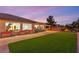 Beautiful backyard featuring turf, stone tile patio, and outdoor seating, perfect for entertaining or relaxing at 20 Kittansett Loop, Henderson, NV 89052