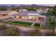 Spacious backyard featuring a covered outdoor kitchen, seating, and artificial turf, great for entertaining and relaxing at 20 Kittansett Loop, Henderson, NV 89052