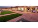 Spacious backyard featuring synthetic turf, stone tile patio, and outdoor seating with beautiful views at 20 Kittansett Loop, Henderson, NV 89052