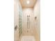 Shower area with decorative glass block and dual shower heads in a neutral color tiled surround at 20 Kittansett Loop, Henderson, NV 89052