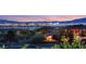 Breathtaking twilight view overlooking the vibrant city skyline, from a lush greenbelt in the foreground at 20 Kittansett Loop, Henderson, NV 89052